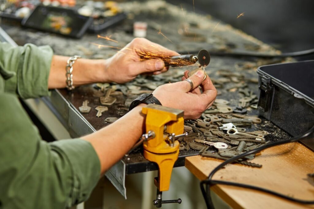 locksmith in workshop makes new key use grinding engraving machine e1696754222654