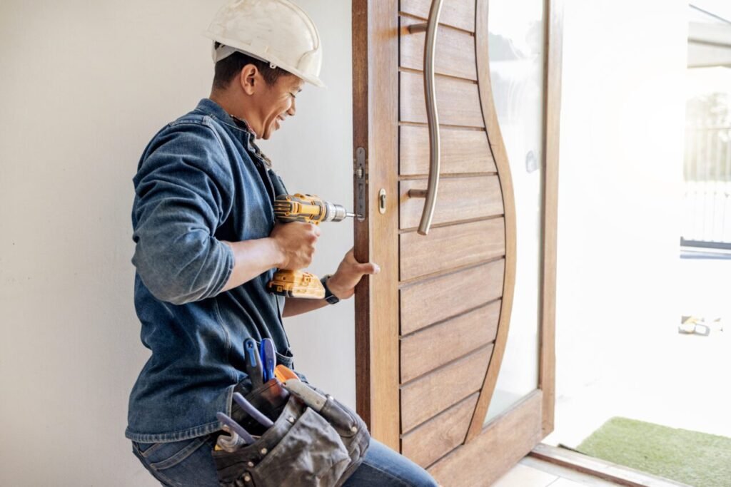 locksmith man and maintenance handyman with home renovation and fixing change door locks with po e1696166441176 1